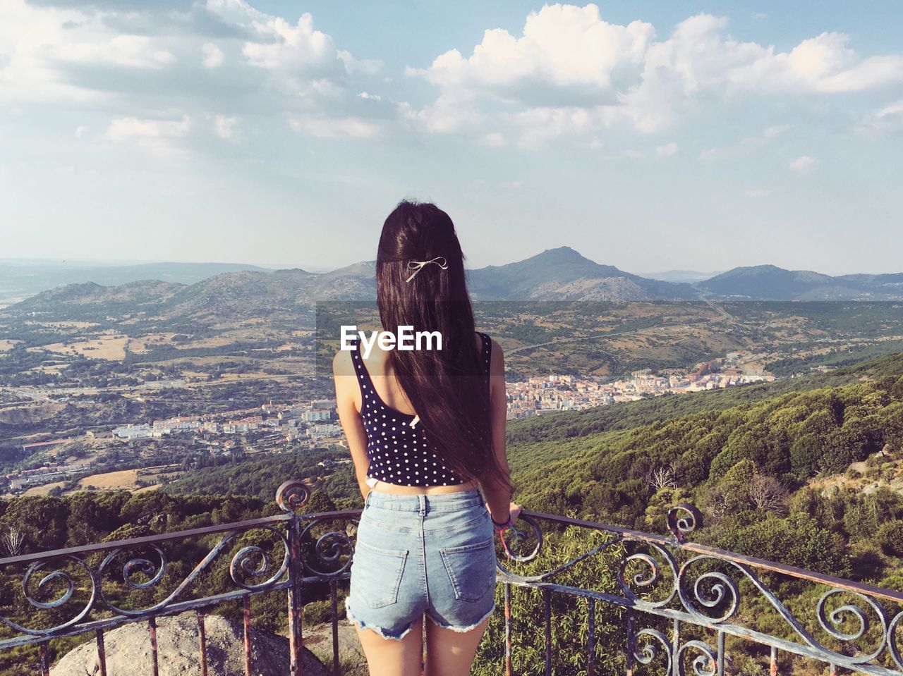 Rear view of young woman standing at observation point