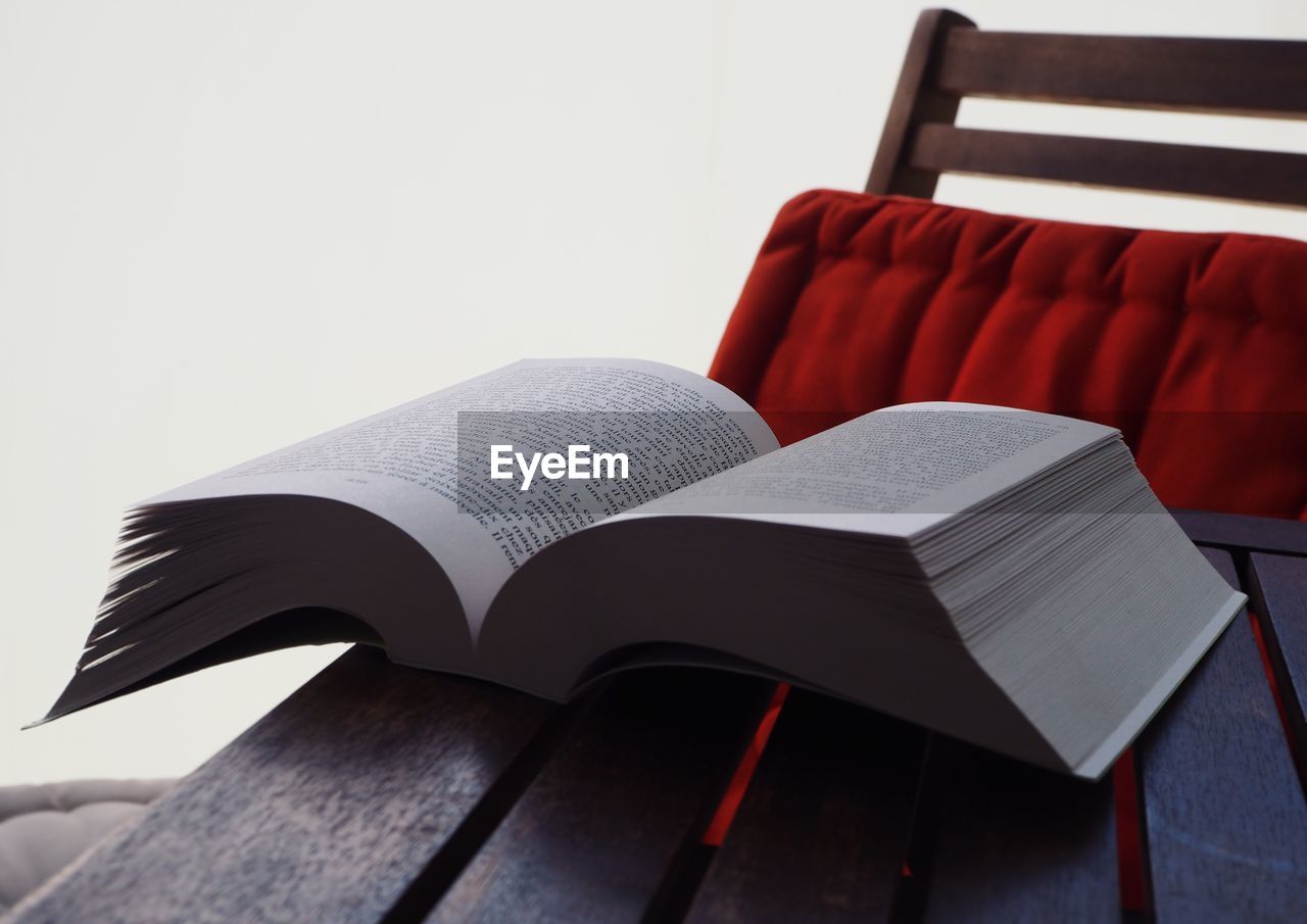 CLOSE-UP OF BOOK ON TABLE