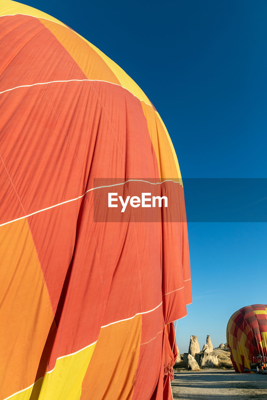 Low angle view of hot air balloon against clear blue sky