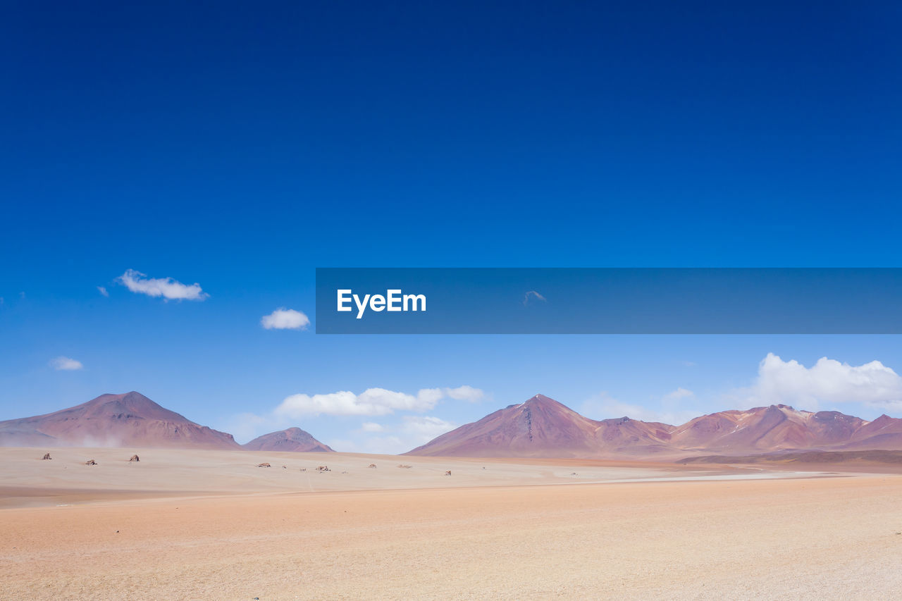 VIEW OF DESERT AGAINST BLUE SKY