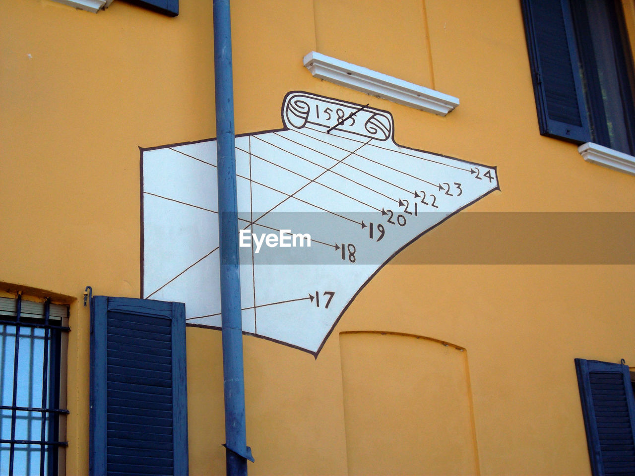 Sundial on an orange facade