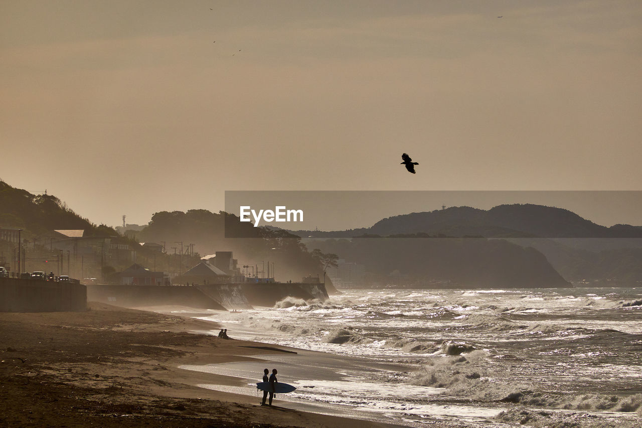 Scenic view of beach against sky during sunrise