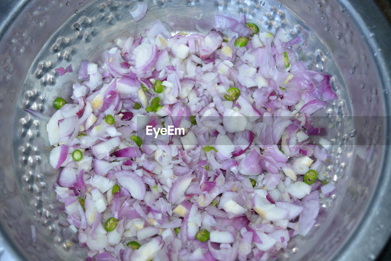 HIGH ANGLE VIEW OF PURPLE FLOWERS IN BOWL ON TABLE