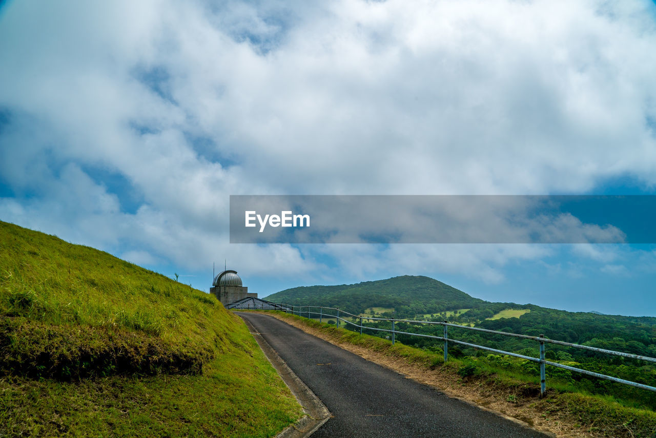 Empty road along countryside landscape