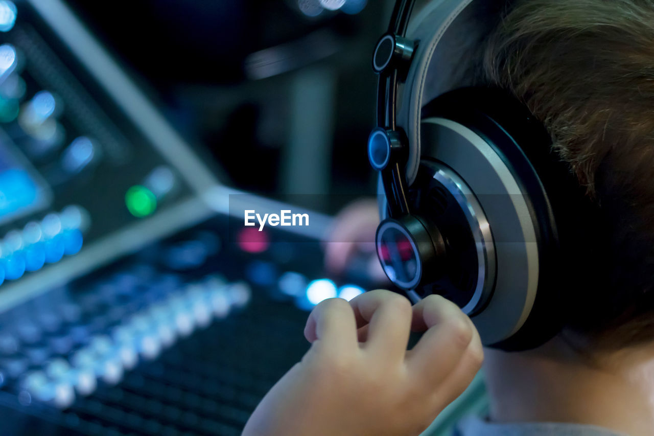 Close-up of boy using sound mixer in studio