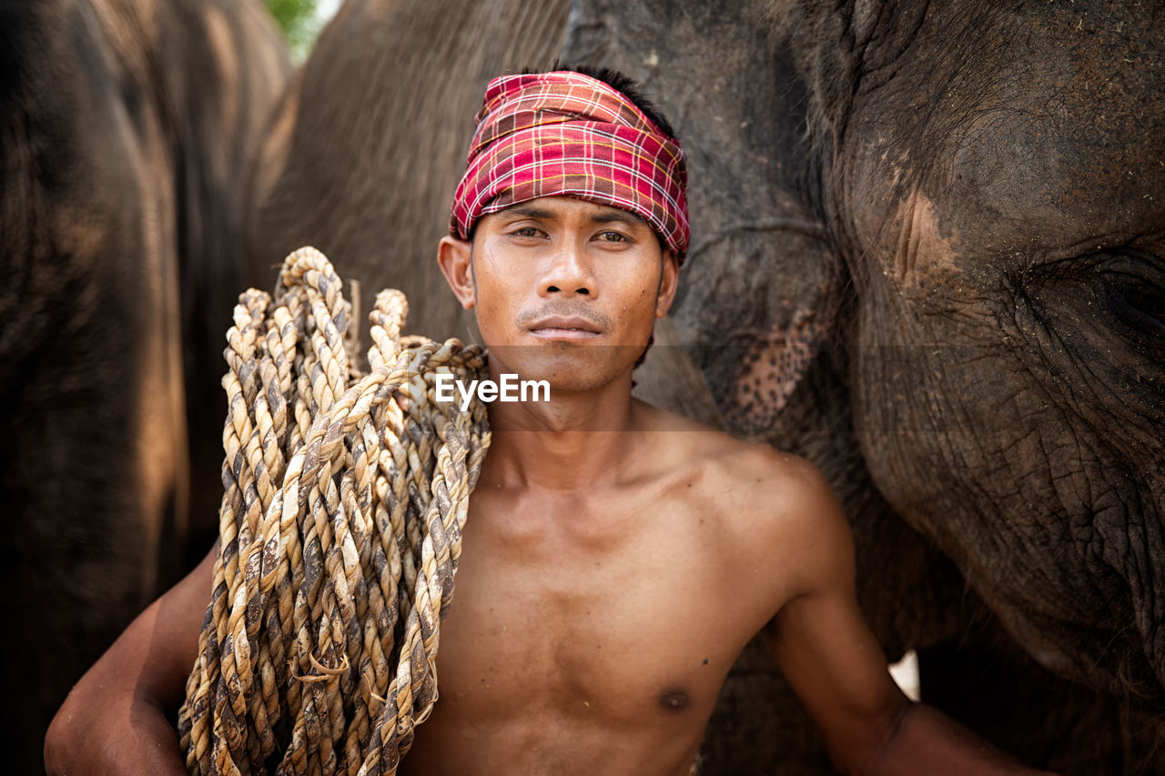 Portrait of shirtless man standing outdoors