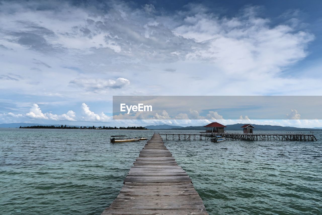 Pier over sea against sky