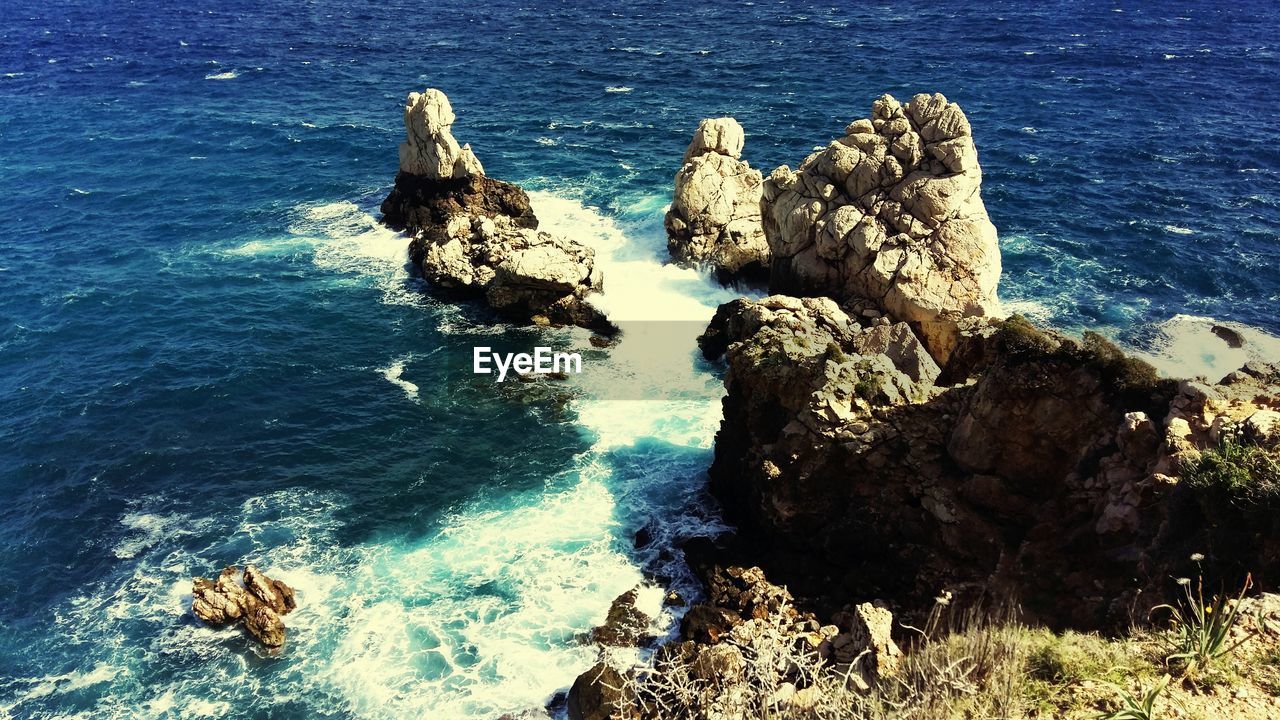 High angle view of rocks by sea