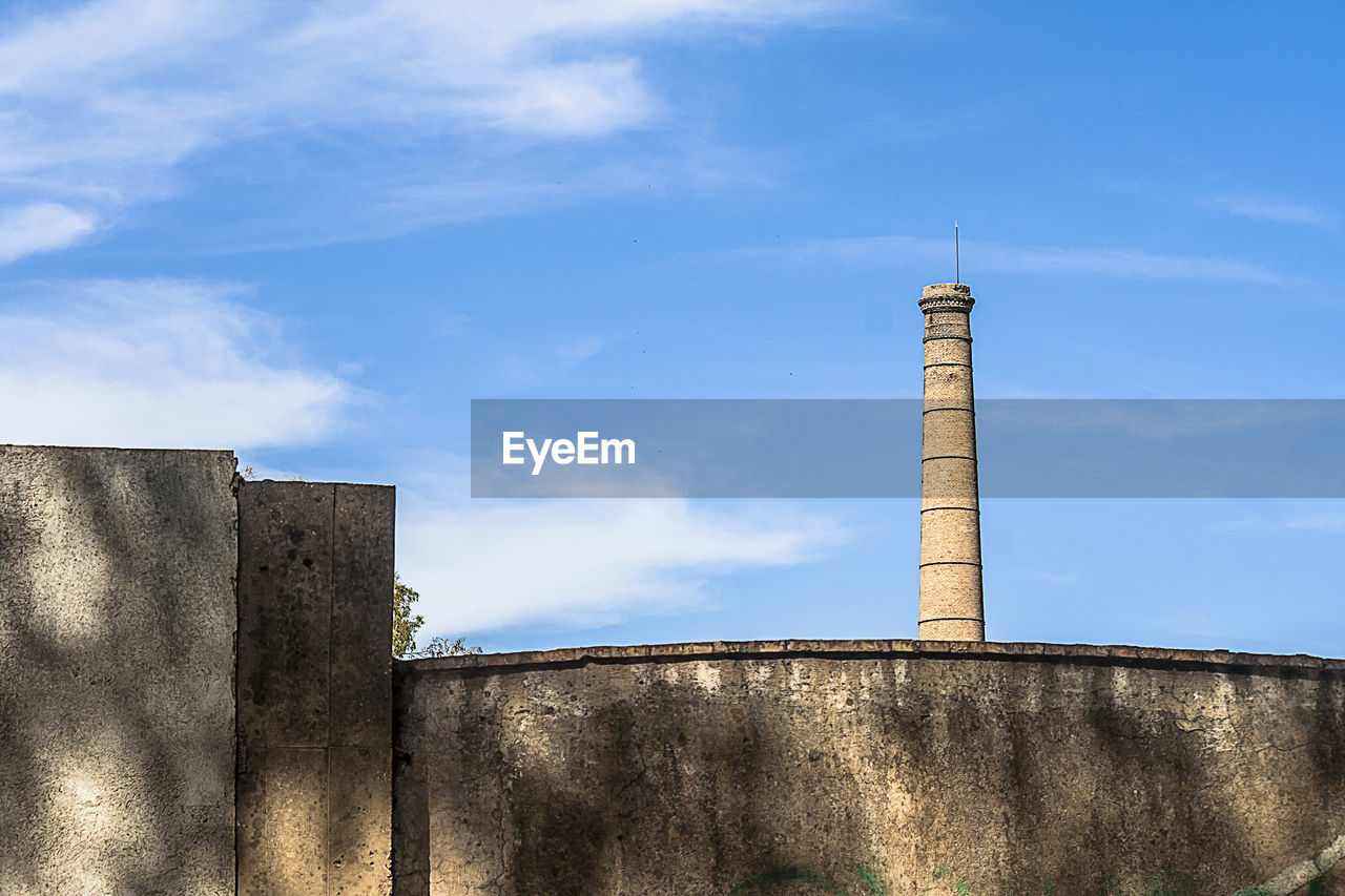 LOW ANGLE VIEW OF SMOKE STACK AGAINST SKY