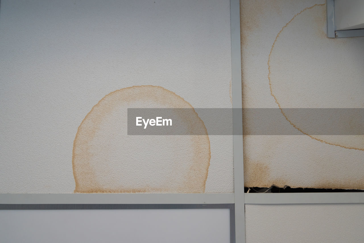 Close-up of white curtain on wall at home