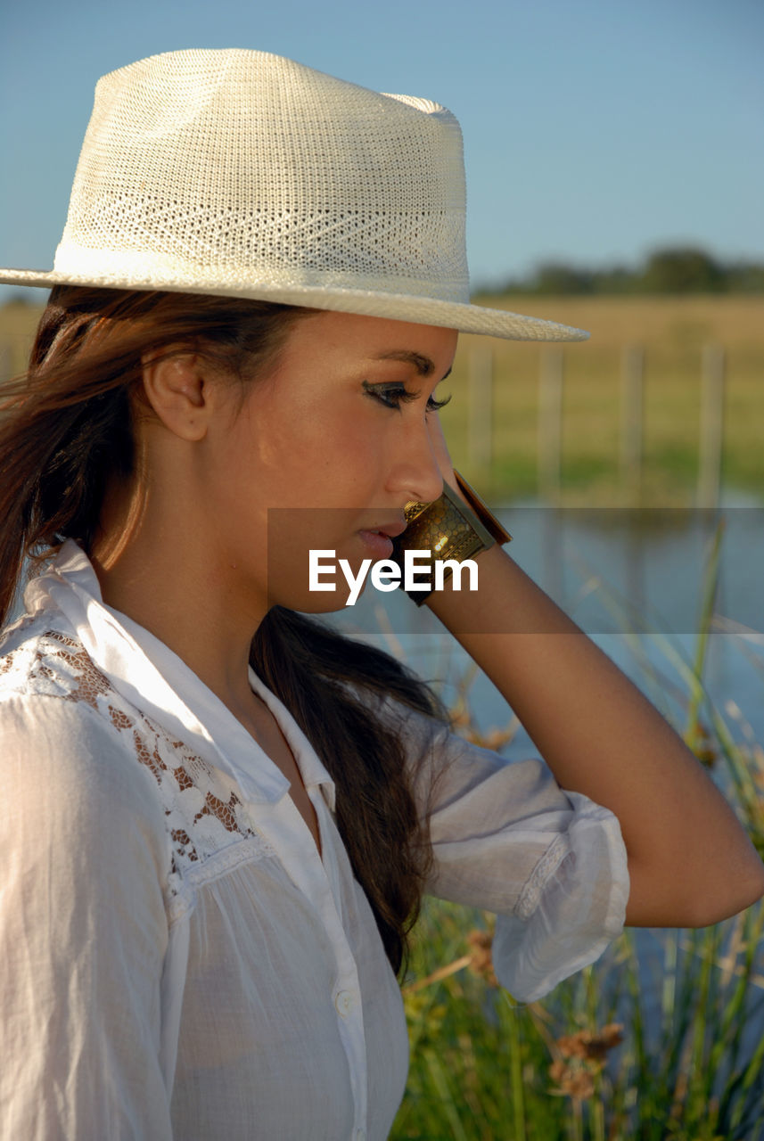 Model with hat in rural area