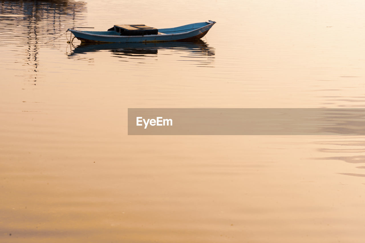 BOAT MOORED ON LAKE