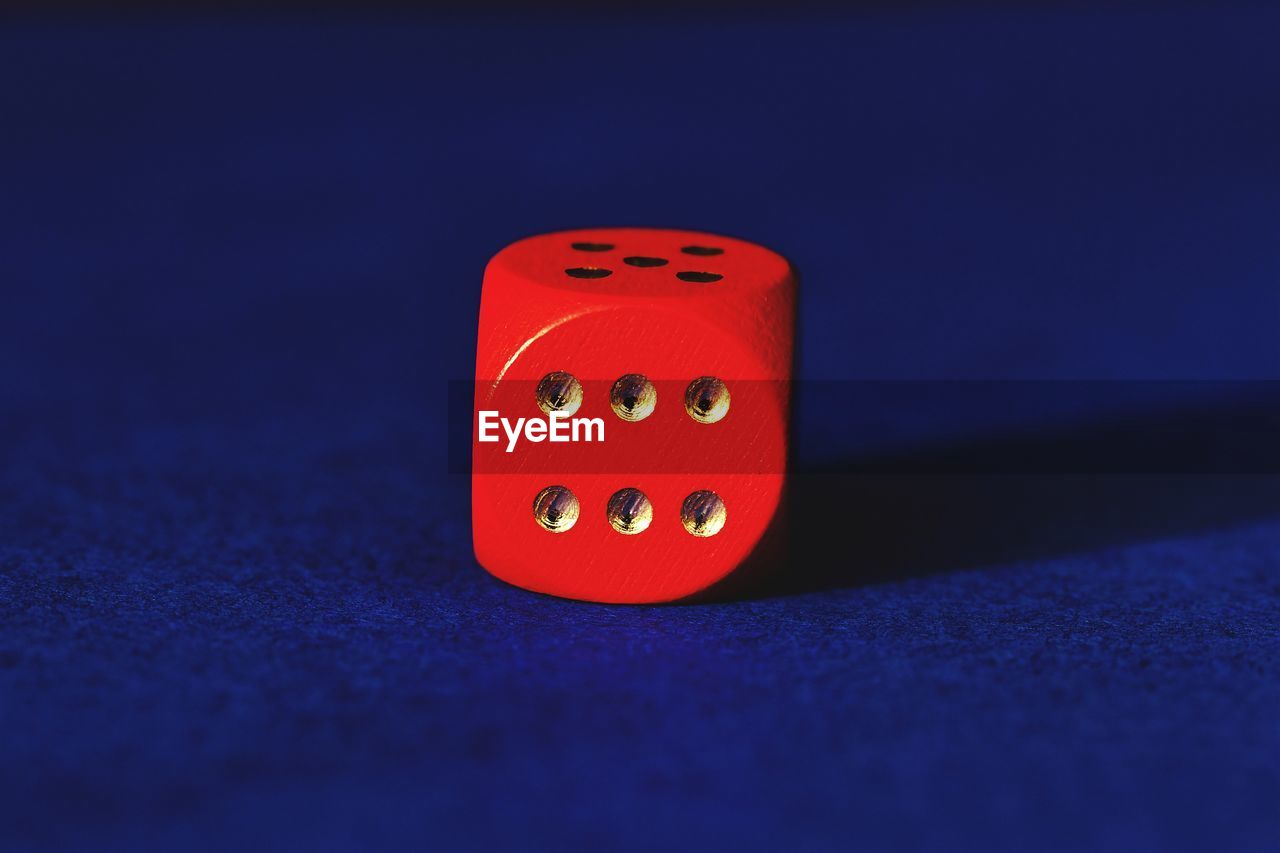 Close-up of red dice on table