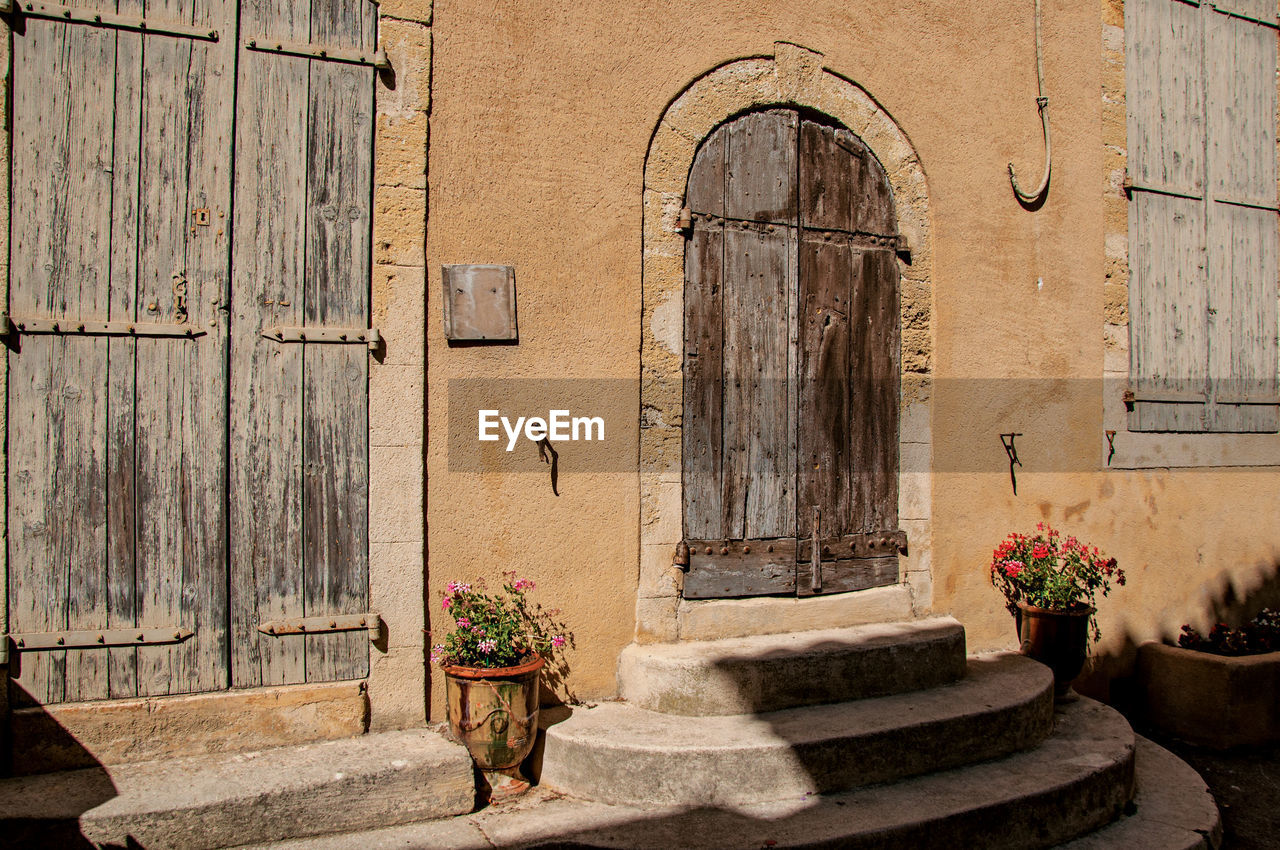 POTTED PLANTS ON OLD BUILDING