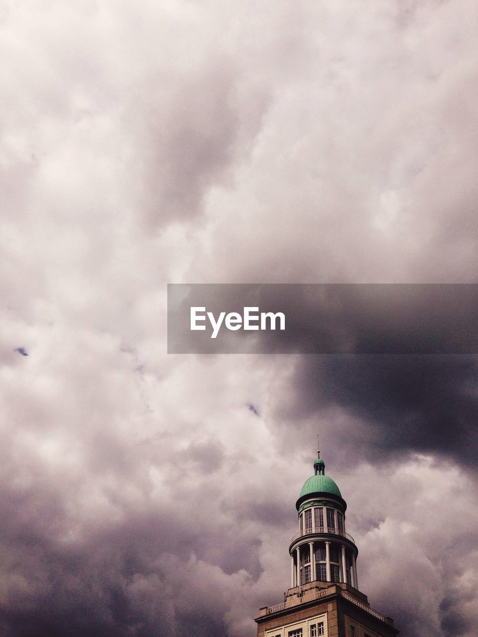 Low angle view of frankfurter tor against cloudy sky