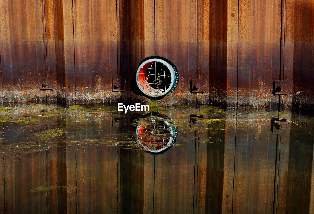 Digital composite image of wooden post with reflection