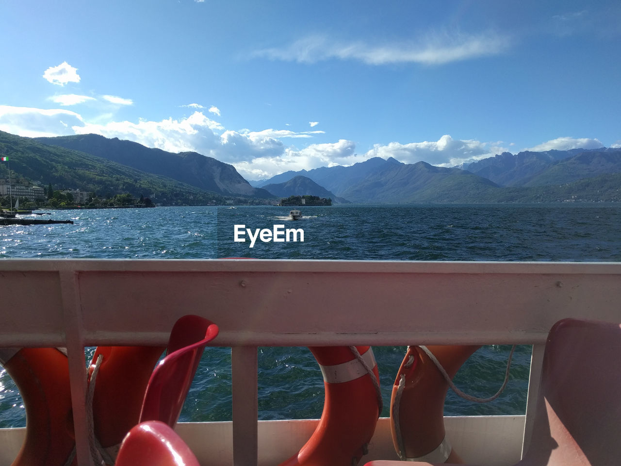 Low section of boats in sea against blue sky