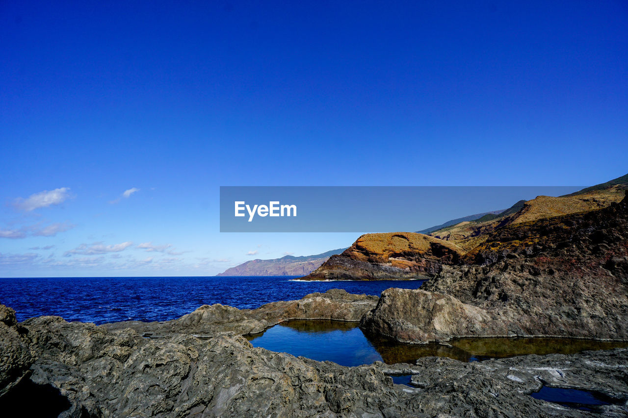 SCENIC VIEW OF SEA AGAINST BLUE SKY