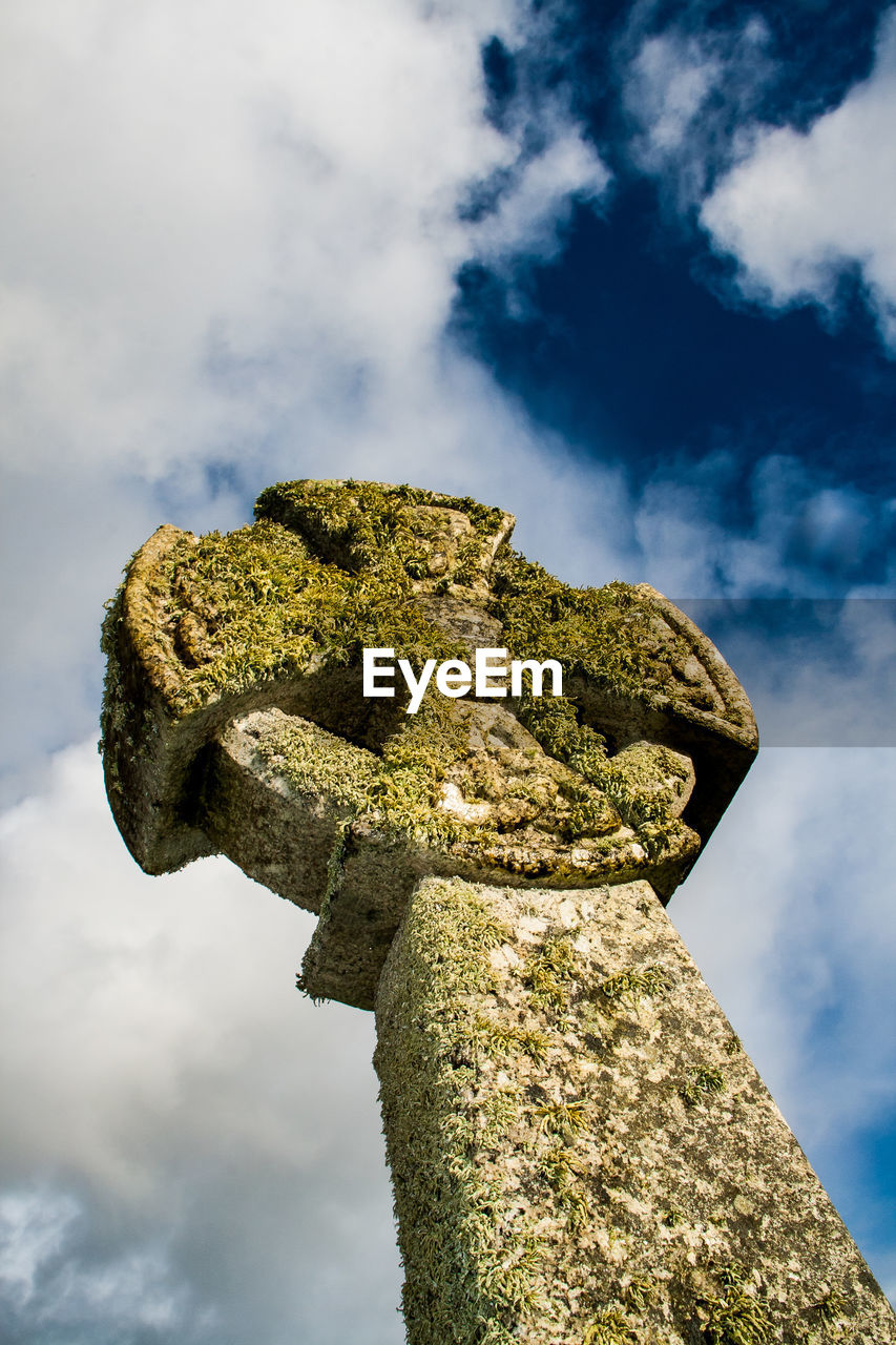 Low angle view of statue against cloudy sky