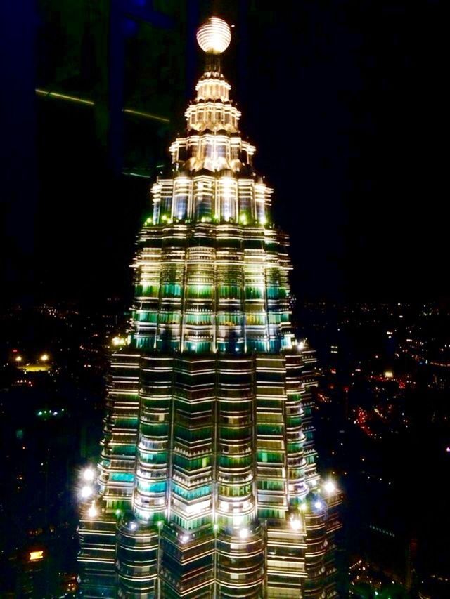 VIEW OF ILLUMINATED CITY AT NIGHT