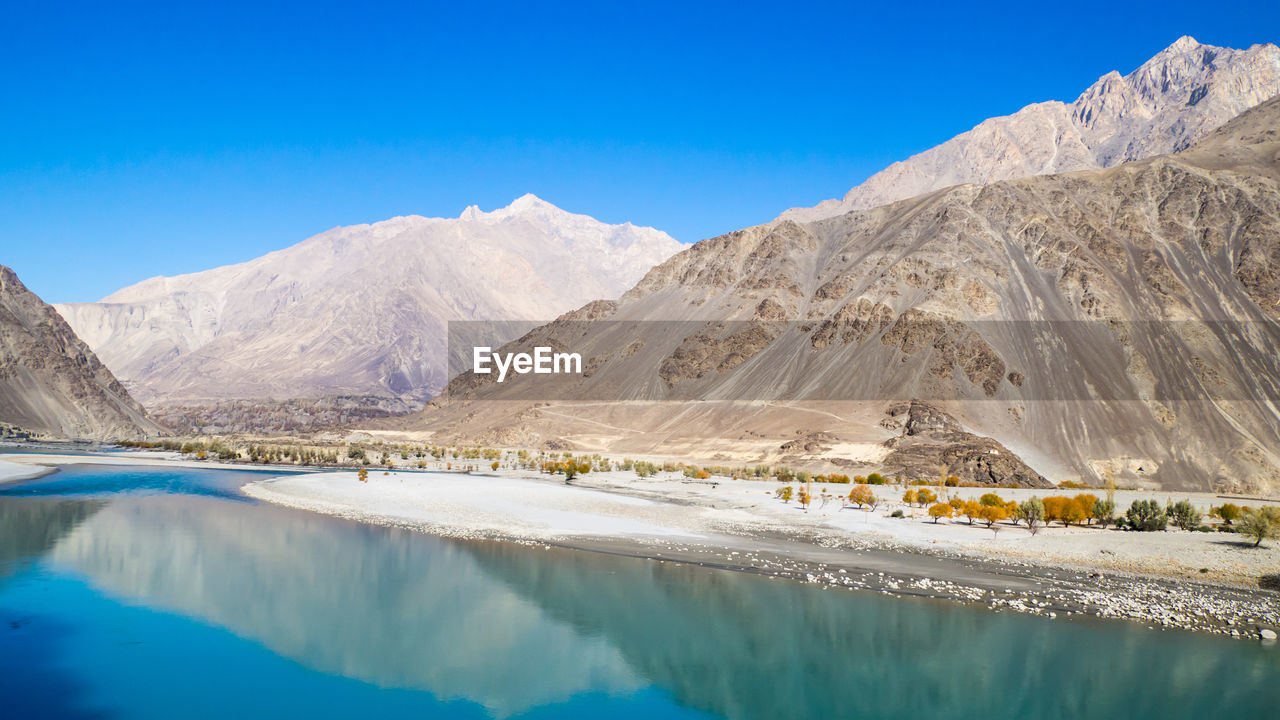 Scenic view of beach against blue sky