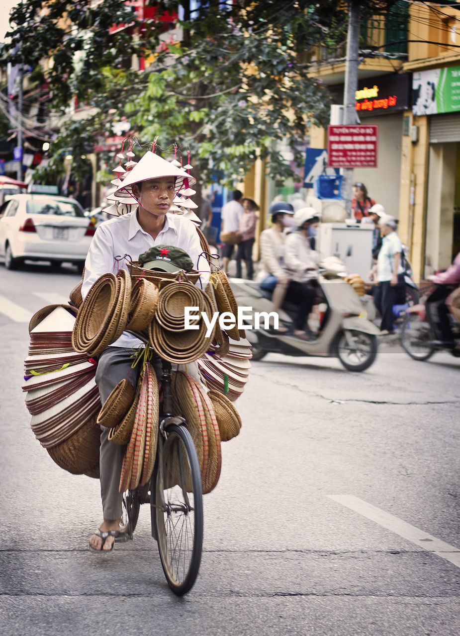 MAN RIDING BICYCLE ON STREET