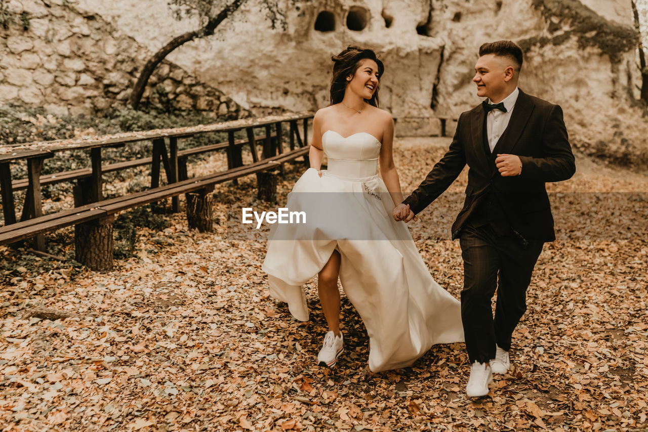 low section of bride and bridegroom standing in farm