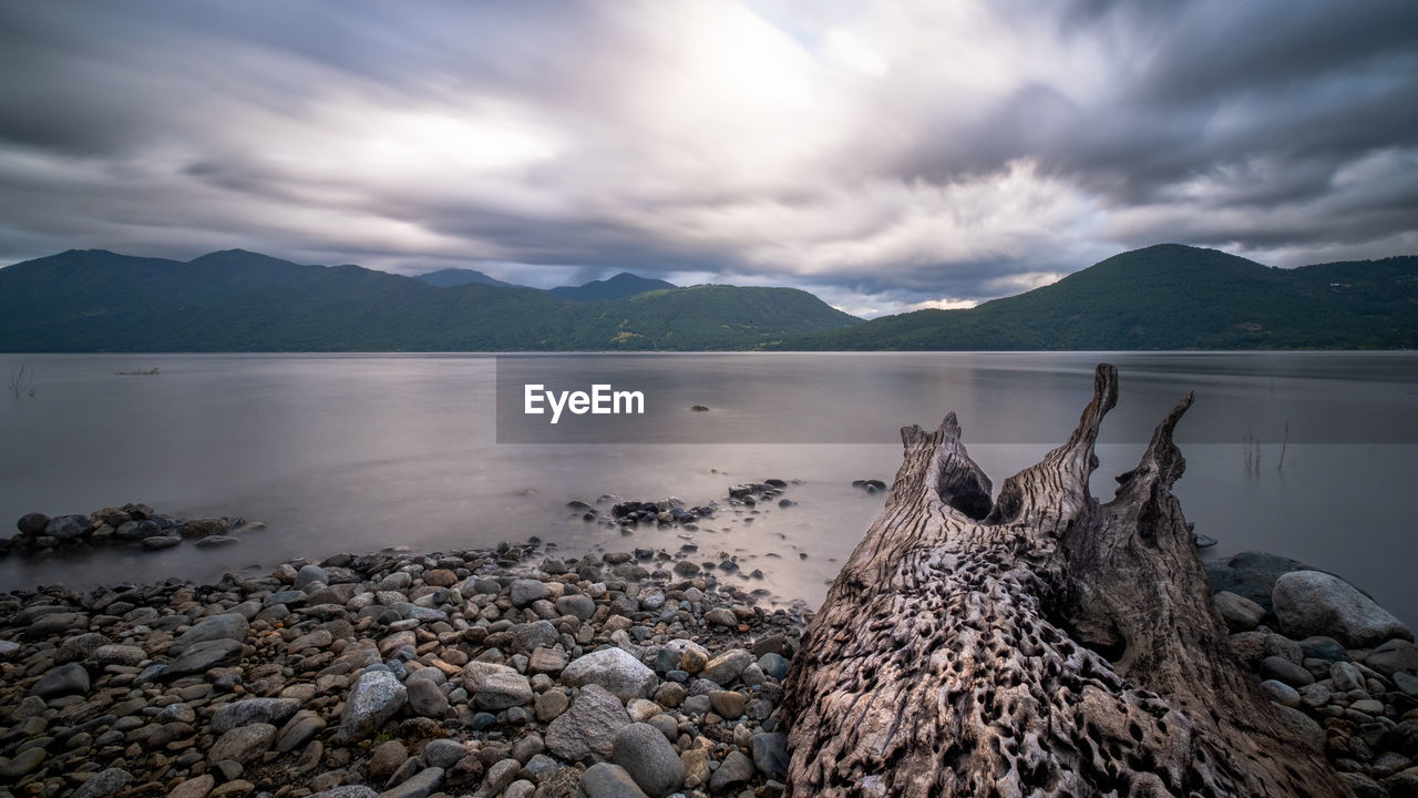 Scenic view of lake and mountains against sky