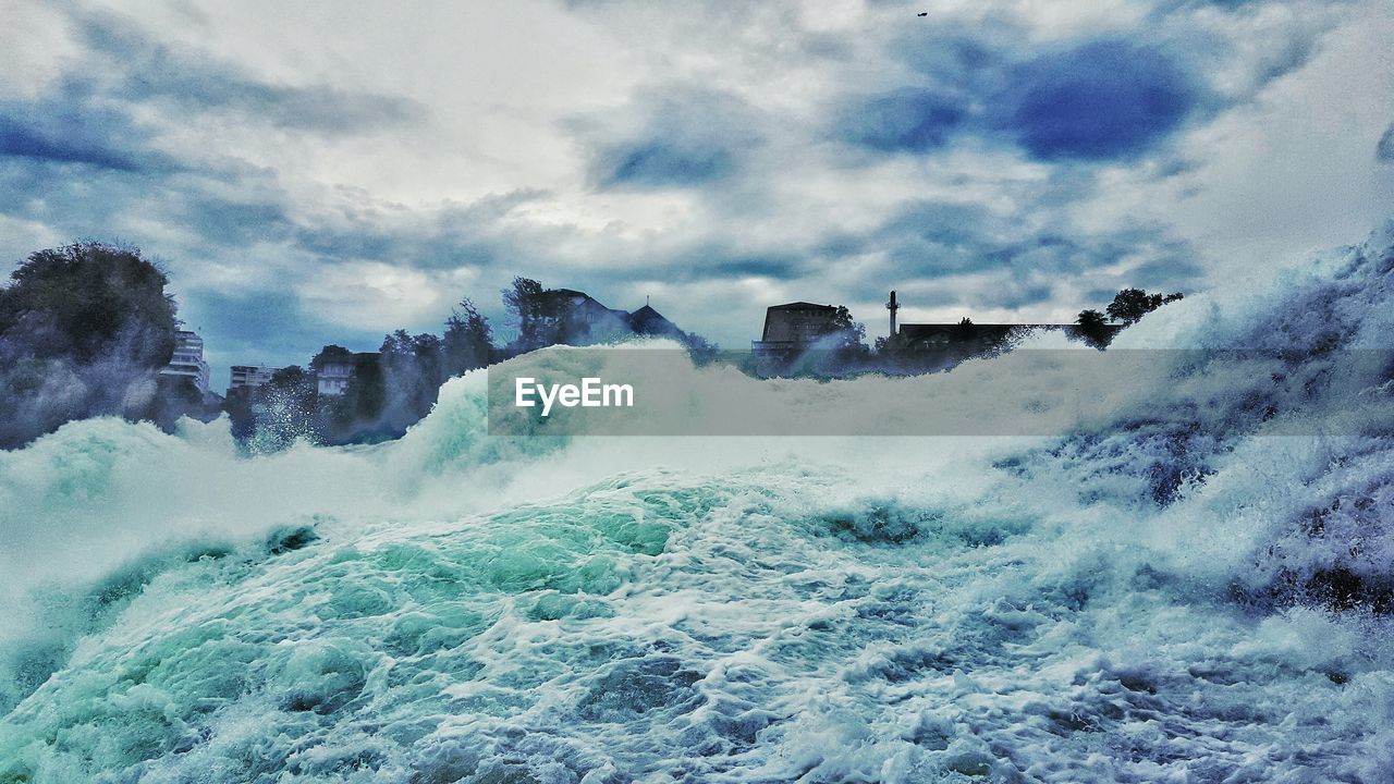 Panoramic view of waves in sea against sky