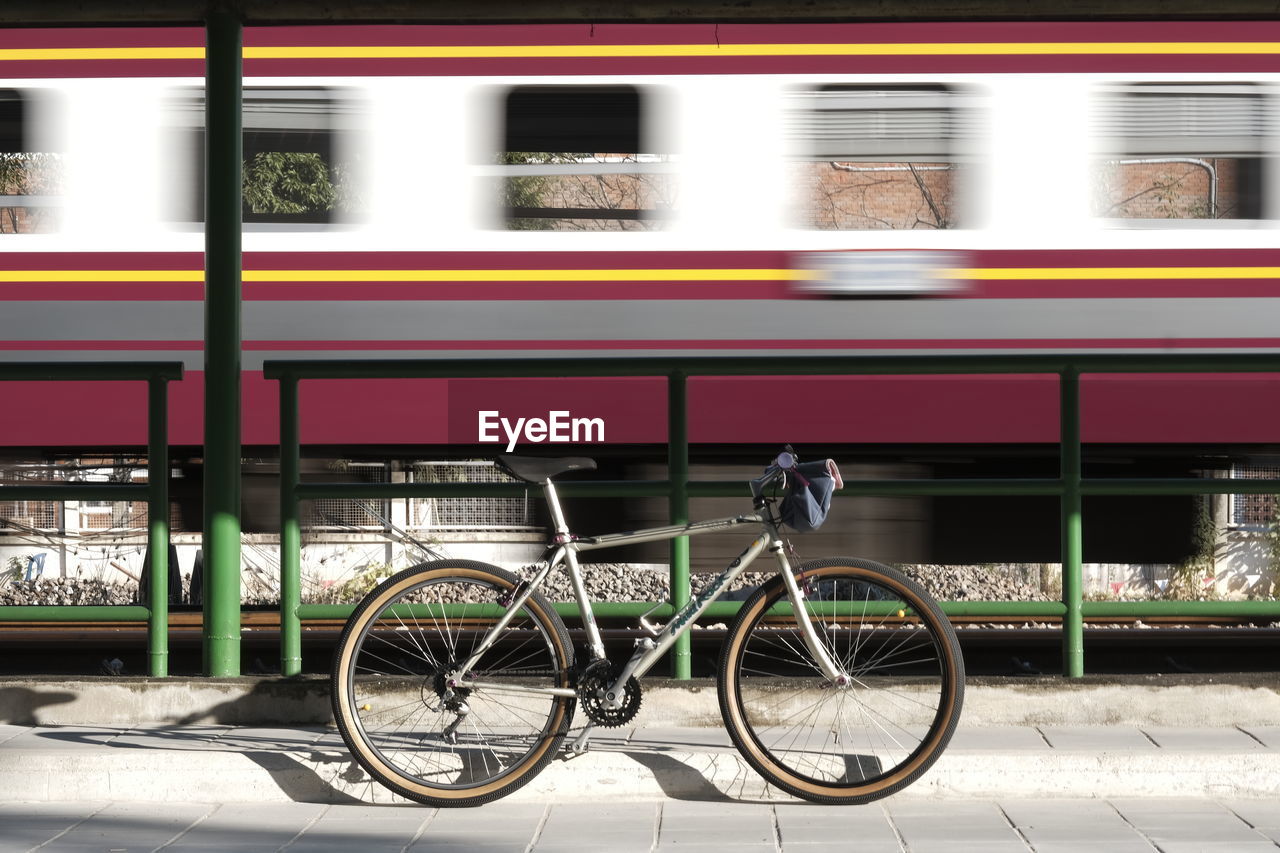 transportation, mode of transportation, vehicle, architecture, land vehicle, bicycle, city, public transportation, transport, rail transportation, no people, travel, street, blurred motion, building exterior, motion, train, built structure, wheel, outdoors, city life, speed, day, subway train