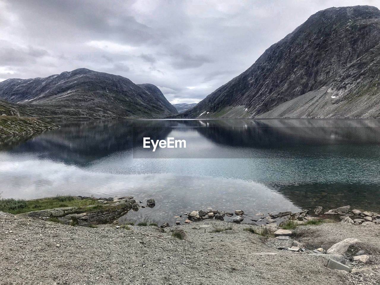 Scenic view of lake amidst mountains against sky