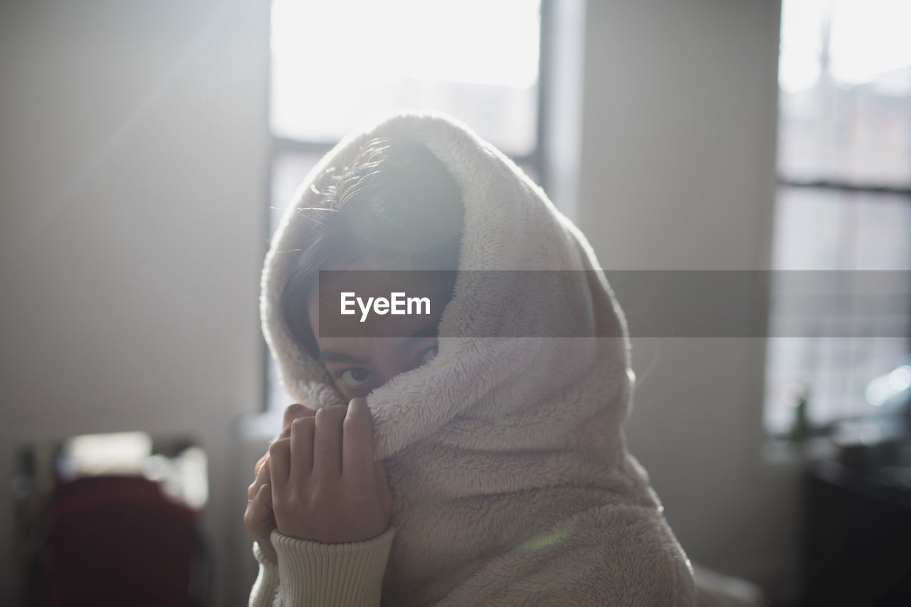 A young woman wearing a hood