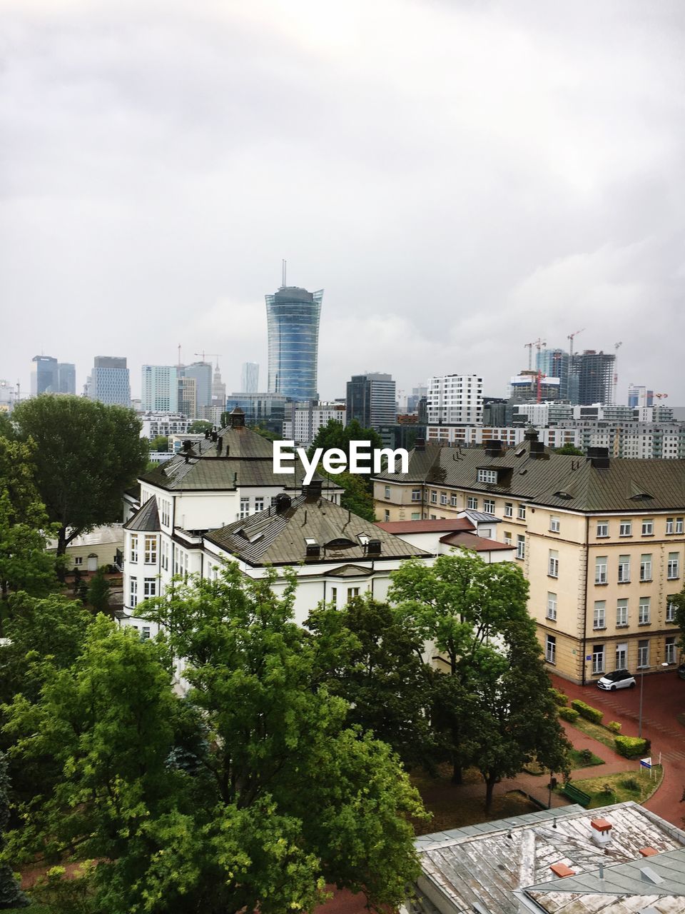 High angle view of buildings and trees against sky