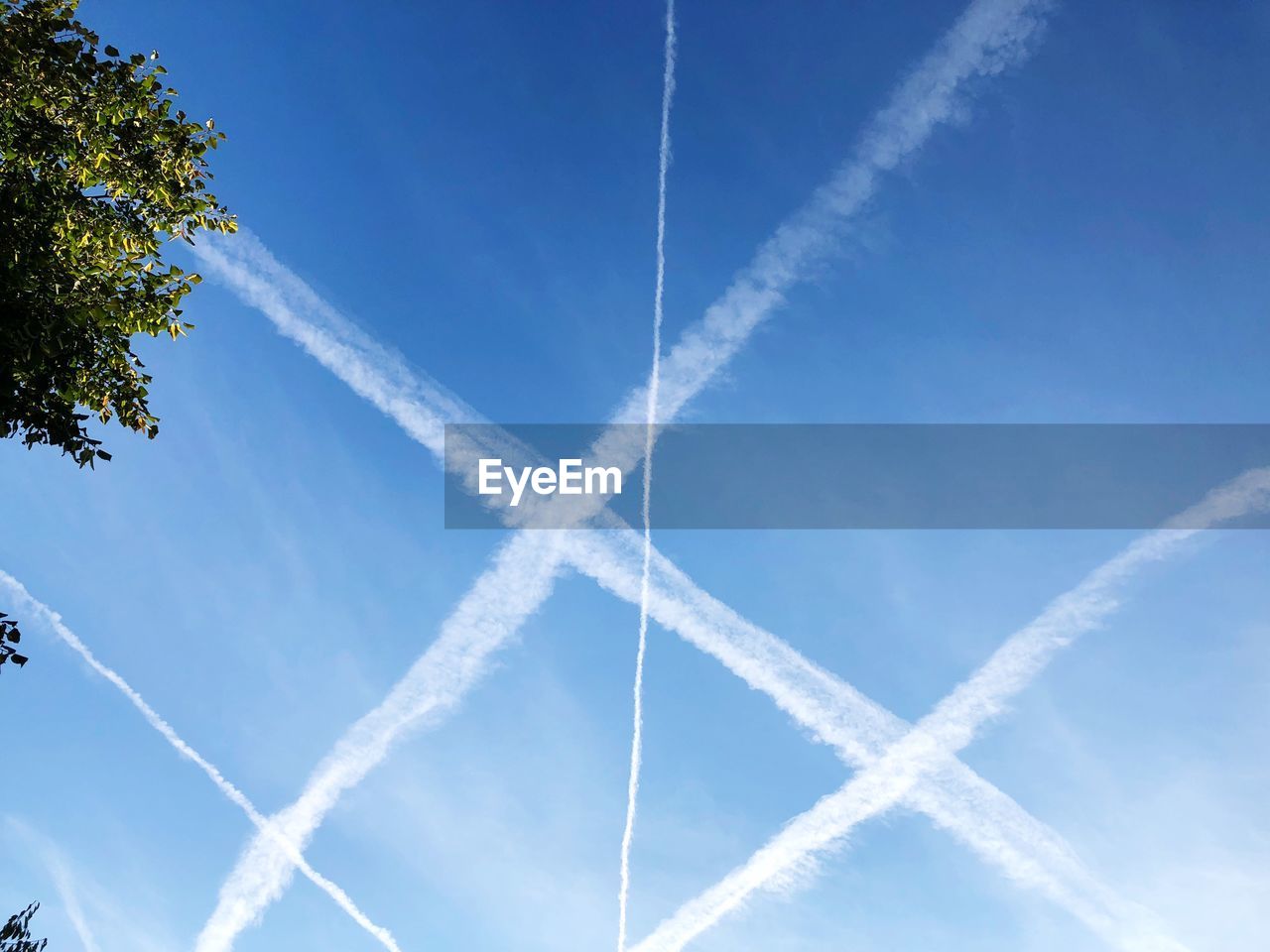 Low angle view of vapor trail against blue sky