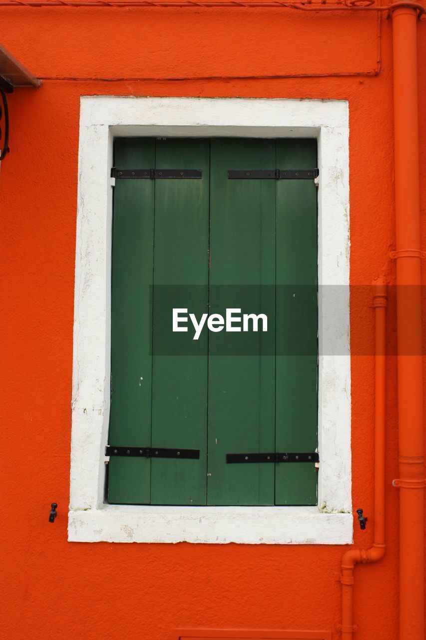 CLOSED WINDOW OF RED BUILDING