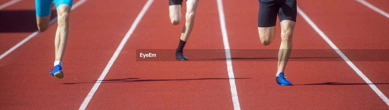 LOW SECTION OF PEOPLE RUNNING ON FLOOR