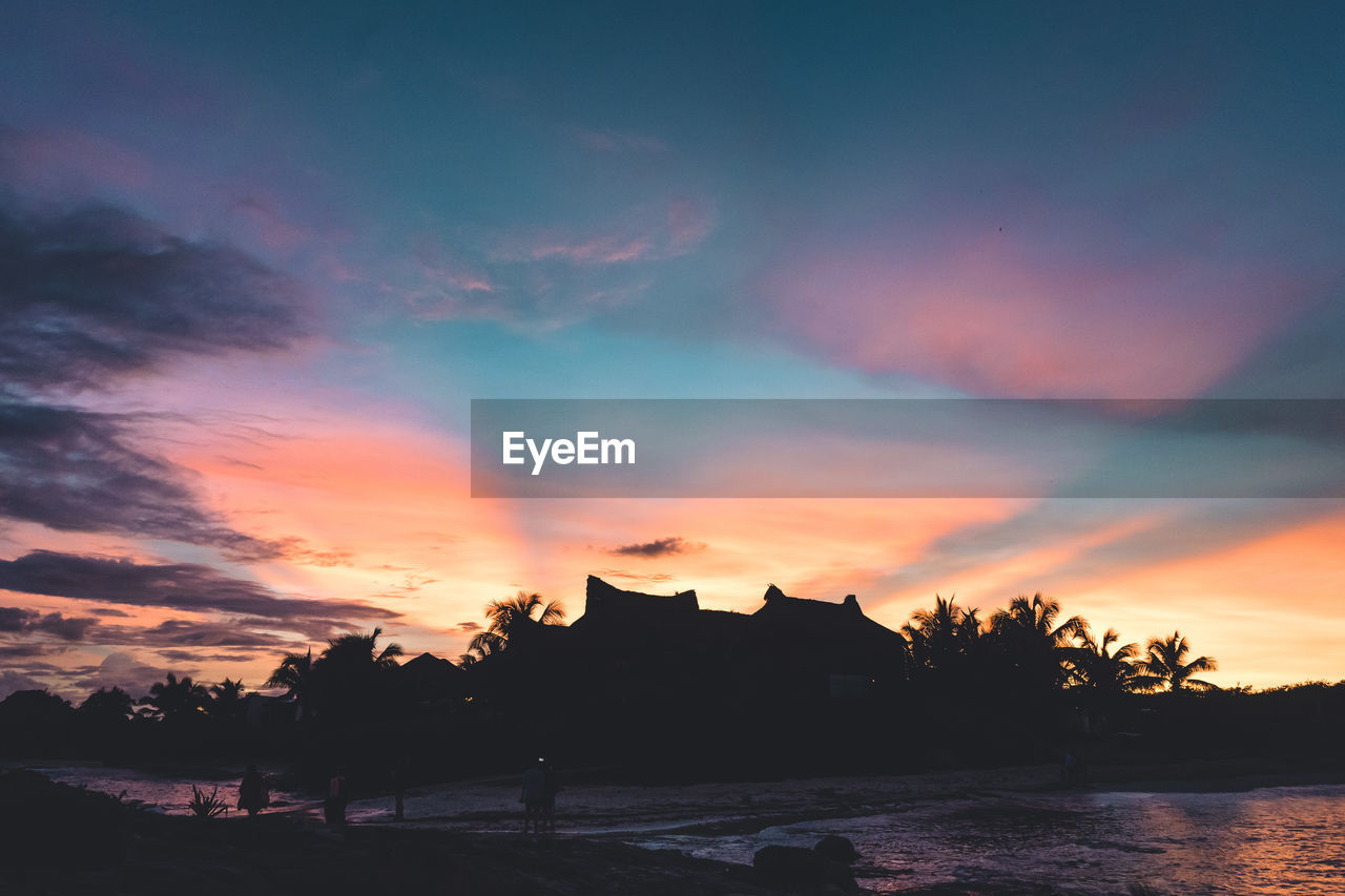 SCENIC VIEW OF LAKE AGAINST ORANGE SKY