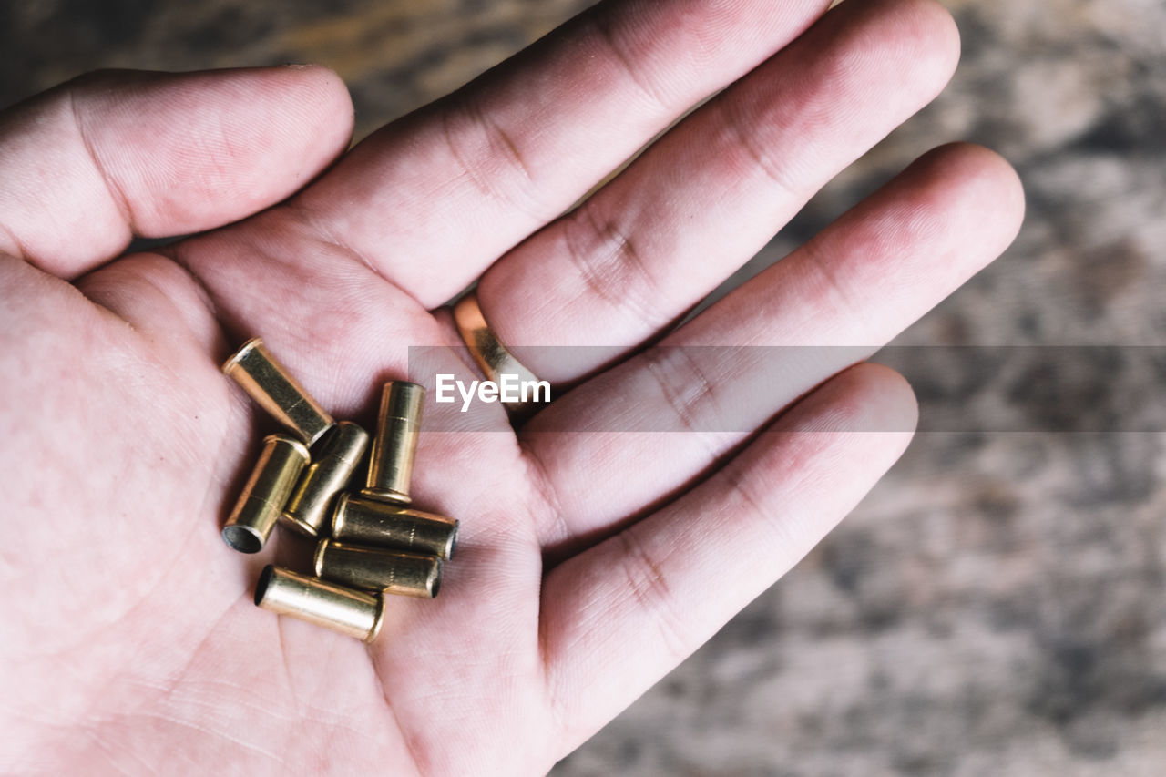 Close-up of hand holding bullets