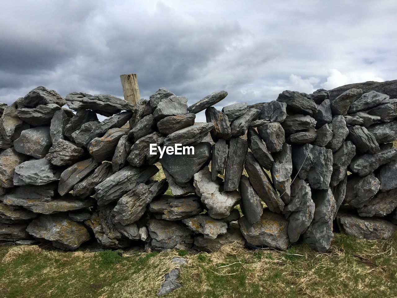 Stack of rocks against cloudy sky