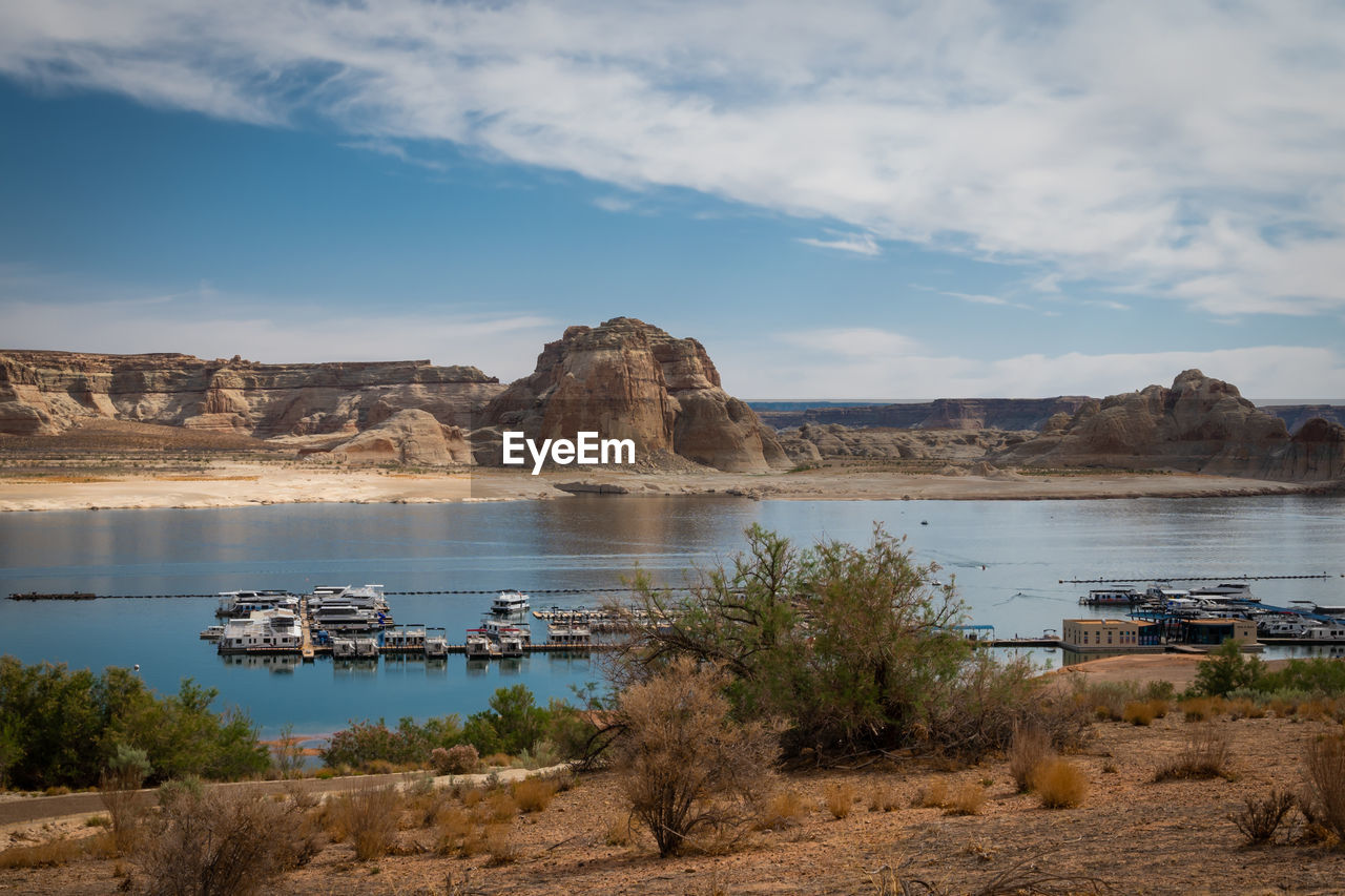 Panorama of boats on lake powell, arizona with low water level.