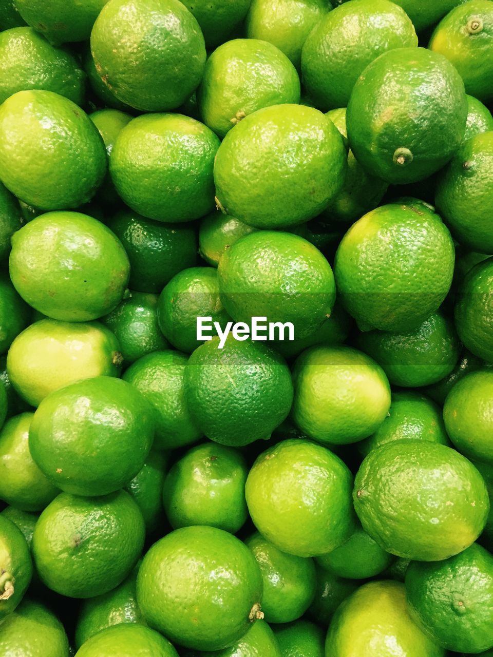 Full frame shot of green lemons.