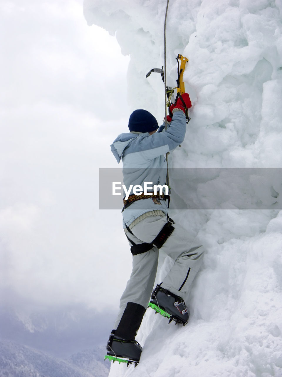Low angle view of person climbing on snow