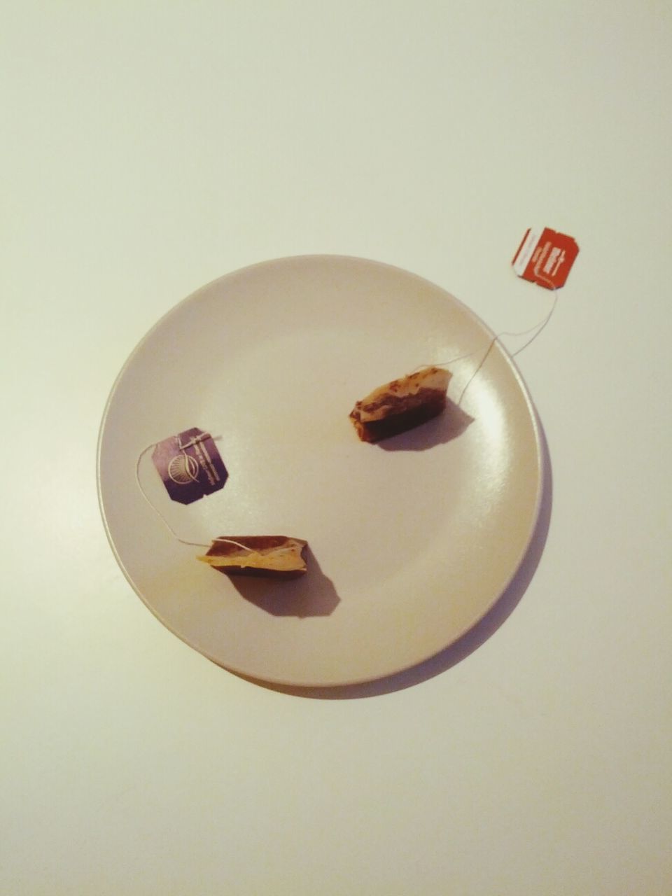 Teabags in plate on table