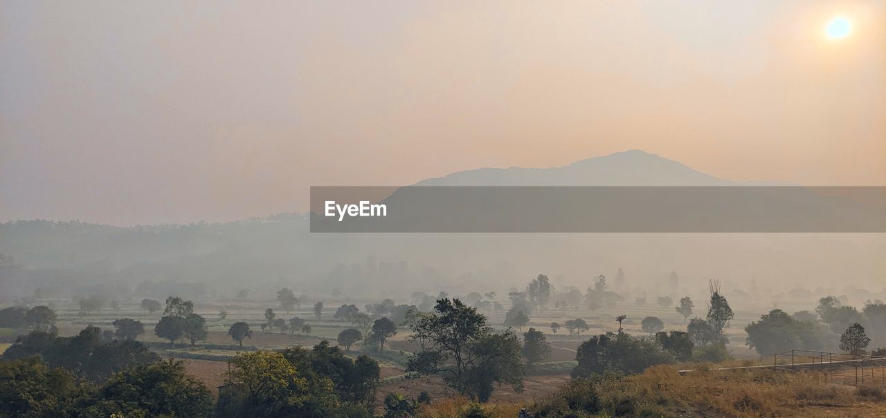 Panoramic view of landscape against sky during sunrise