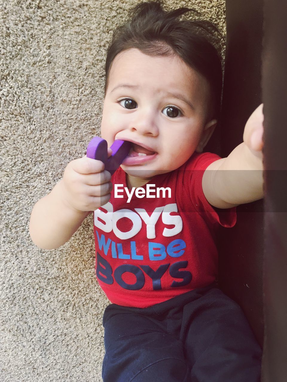 Portrait of cute baby boy against wall