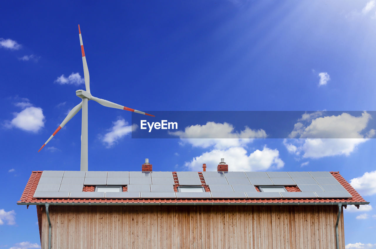 LOW ANGLE VIEW OF TRADITIONAL WINDMILL AGAINST BUILDING