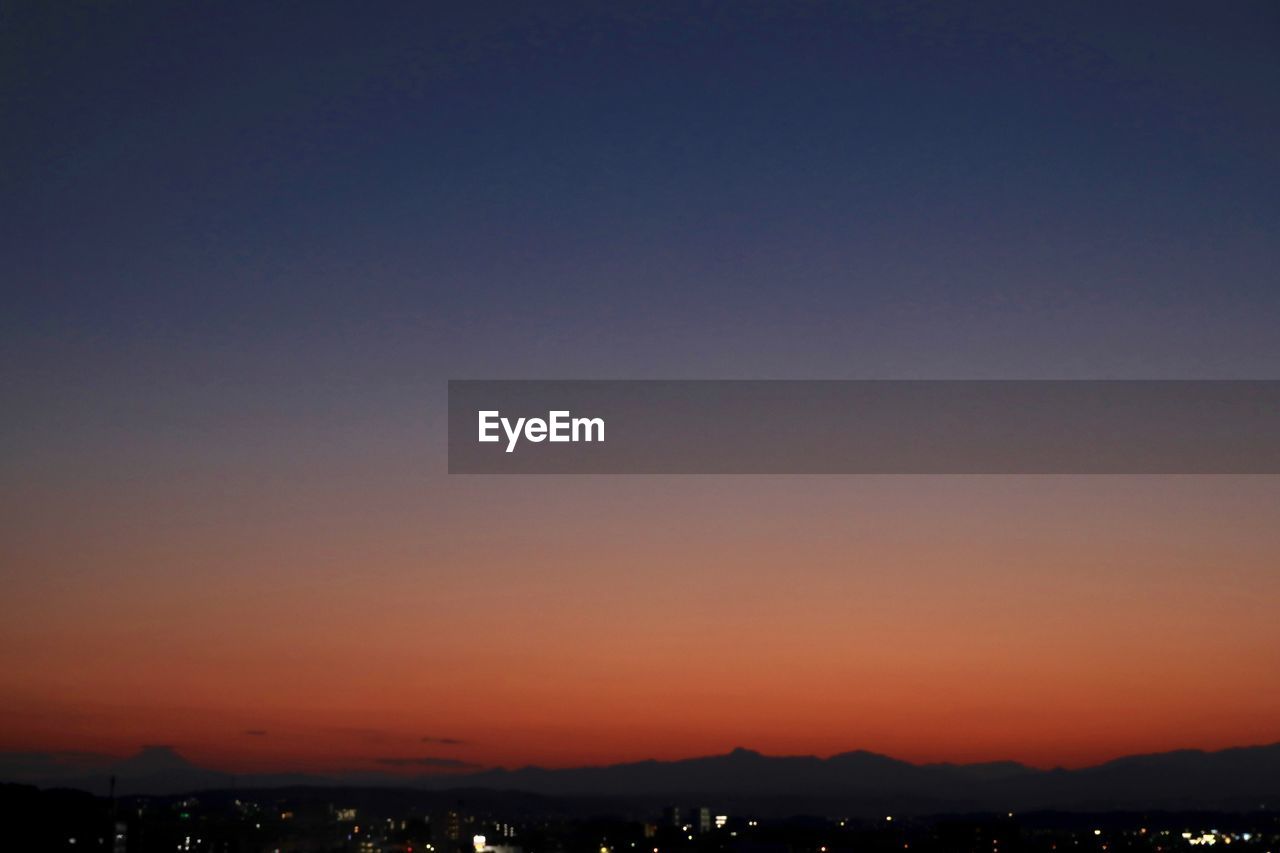 SILHOUETTE CITY AGAINST CLEAR SKY AT SUNSET