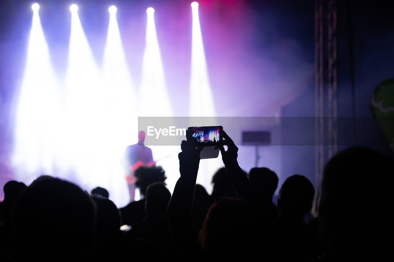 PEOPLE PHOTOGRAPHING AT NIGHT