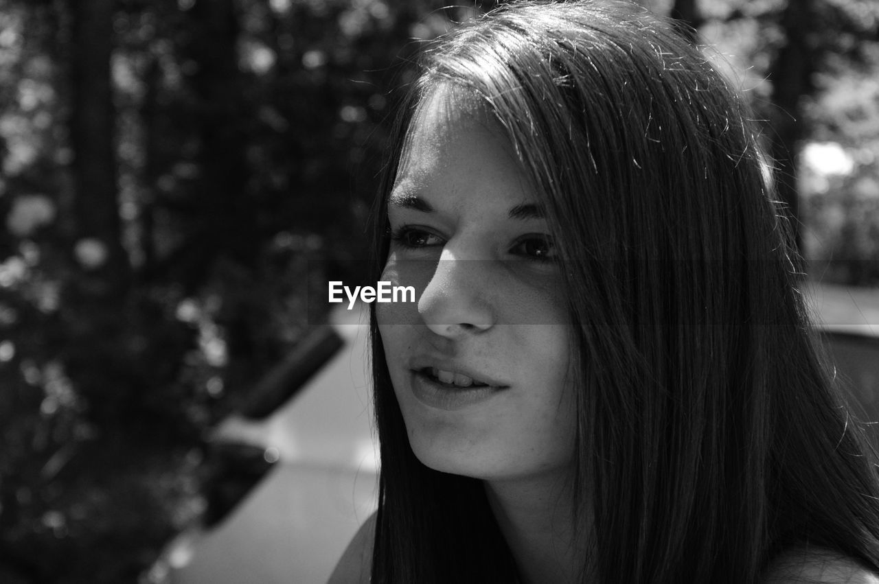 Close-up of beautiful young woman looking away