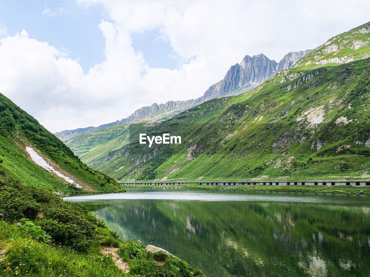 Scenic view of lake and mountains against sky